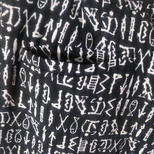 Black pants with Egyptian motifs.